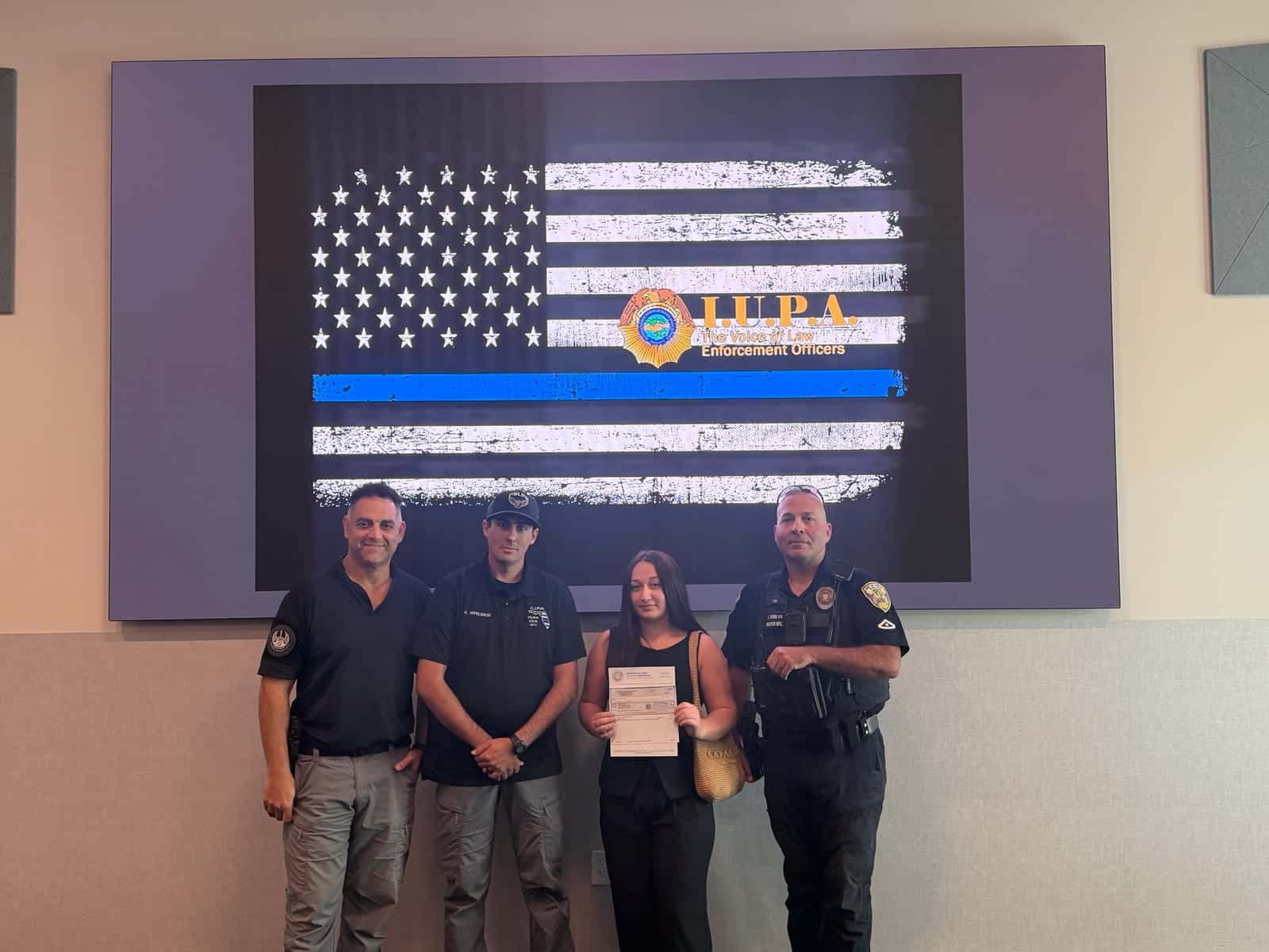 Madison Wilkins holds her Edward J. Kiernan Memorial Scholarship check beside members of the Port St. Lucie Police Officers Association