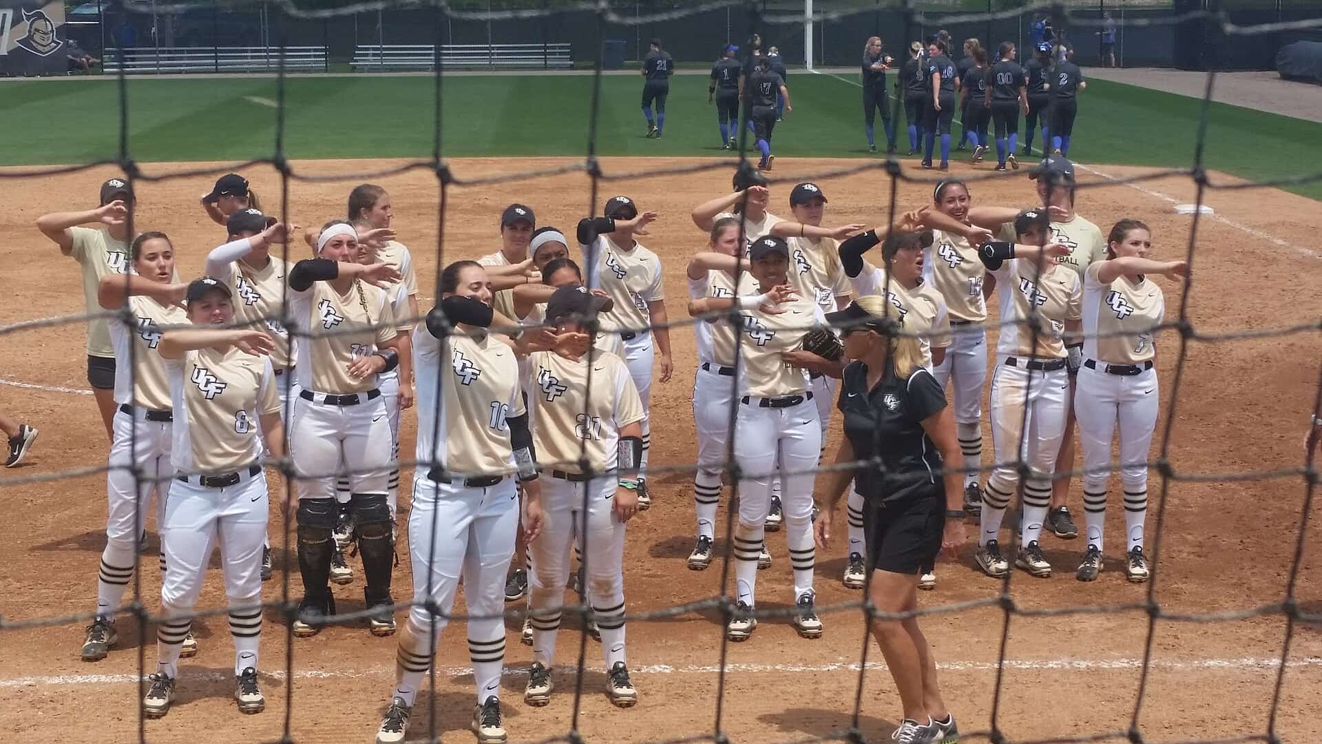 UCF Knights softball players line up on the field