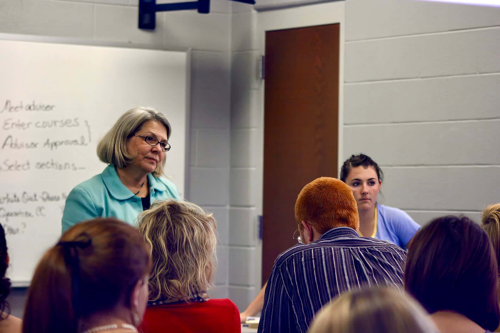 A teacher leads a lesson at a whiteboard
